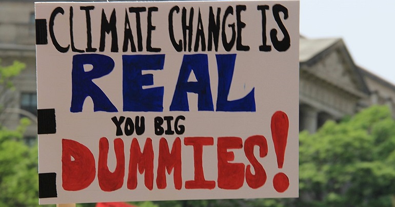 Placard reading: climate change is real you big dummies