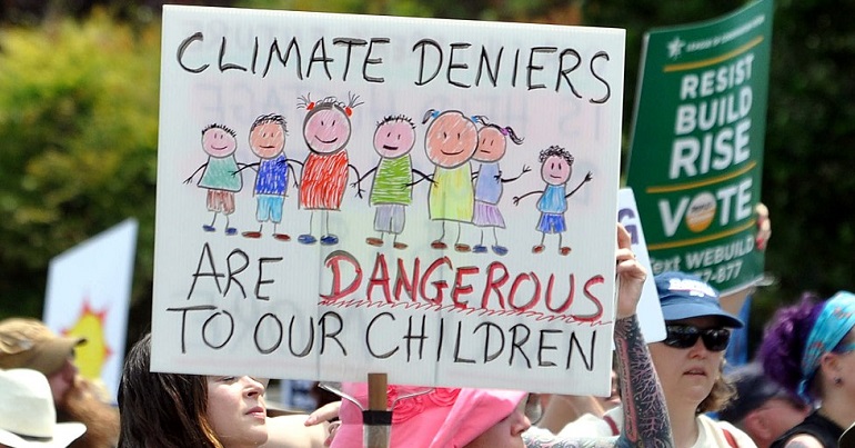 Climate change protest placard reads: "Climate deniers are dangerous to our children"