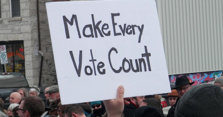 Placard reading "Make every vote count"