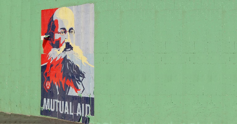 Image of Kropotkin graffiti on a wall with the text "mutual aid"