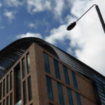 An image of the Francis Crick Institute, cloudy blue sky