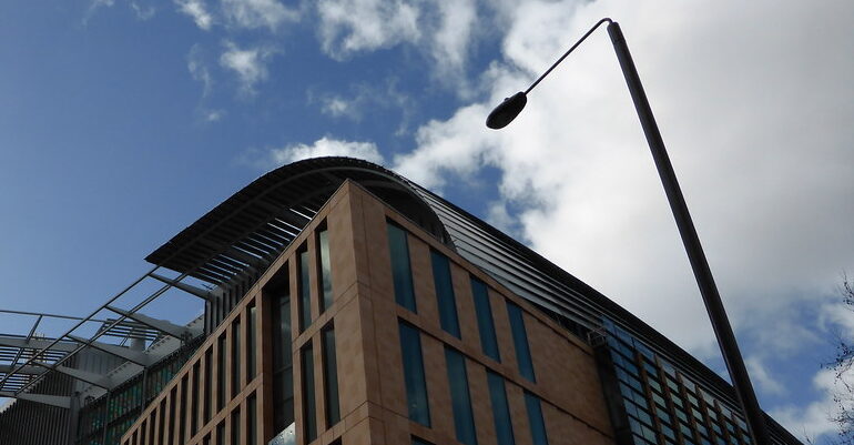An image of the Francis Crick Institute, cloudy blue sky