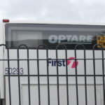 Optare made bus, behind a fence