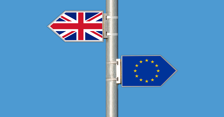 UK and EU flags on a signpost, symbolising Brexit
