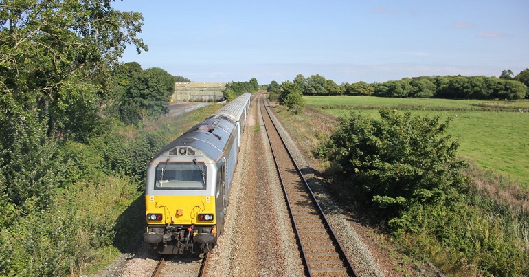 A train passing through fields in Wales