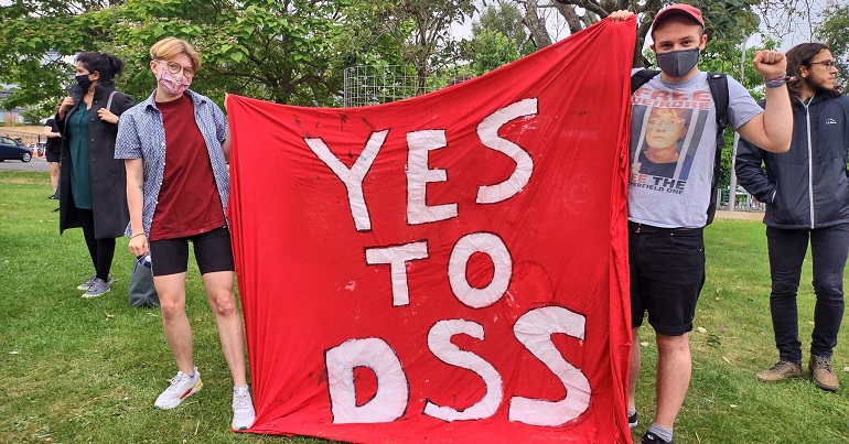 A photo of Lucy Pegg and Chris Jarvis with a banner reading "Yes to DSS"