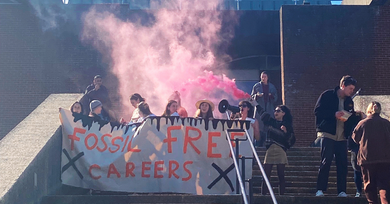 Campaigners at Sussex University holding a banner reading "fossil free careers" 
