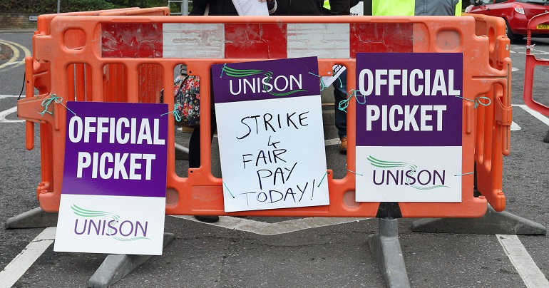 A photo of Unison placards reading "Official Picket"