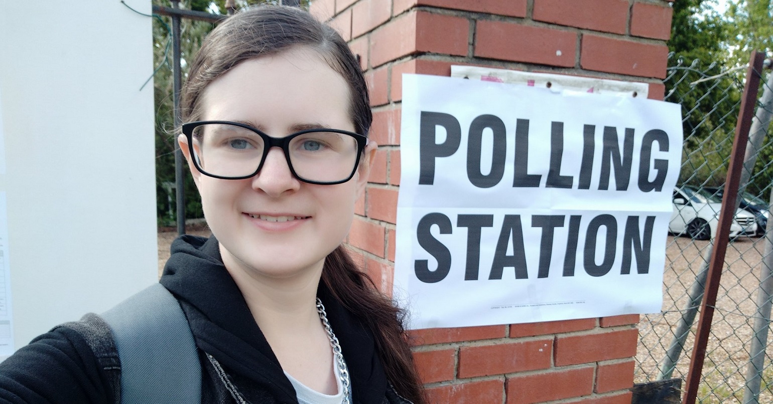 Natalia Kubica standing in front of a polling station sign