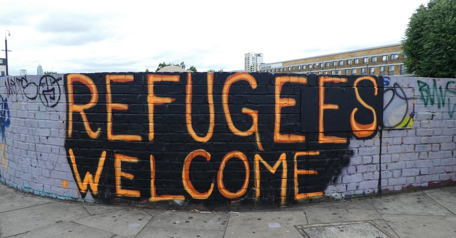 A mural reading "refugees welcome"