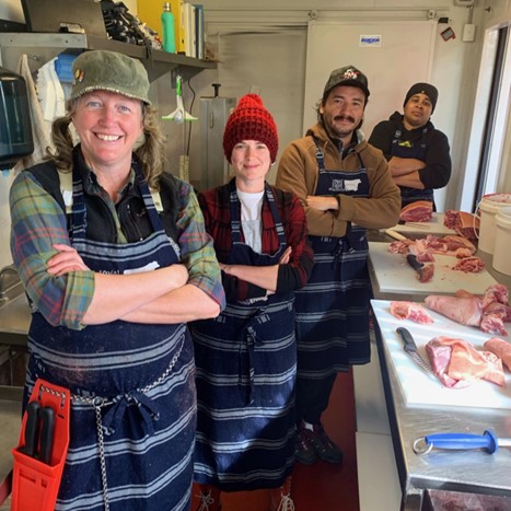 Tammi Jonas and their team standing next to cuts of meat