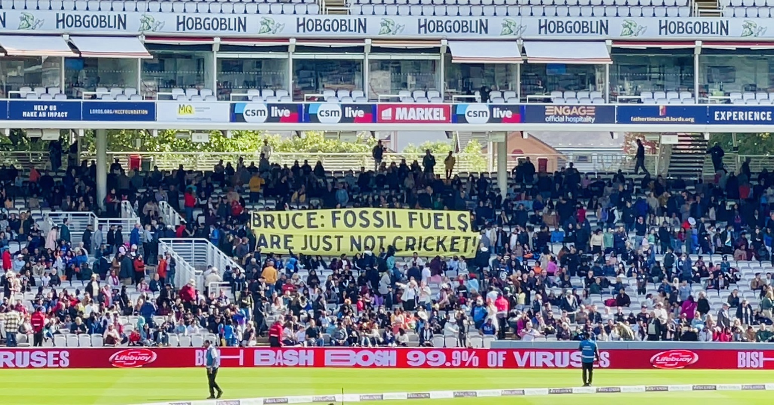 A photo of a banner at Lord's Cricket Ground reading "Bruce: Fossil Fuels are Just Not Cricket" 