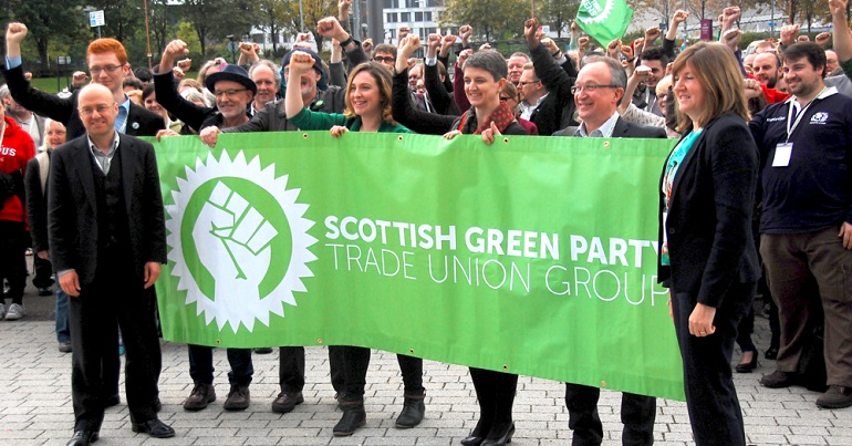 Scottish Green Party politicians holding the Scottish Green Party Trade Union Group banner