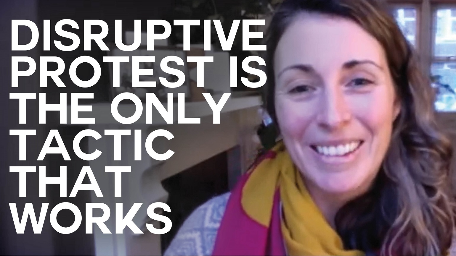 A still of an interview with Chloe Naldrett of Just Stop Oil with text overlaid reading "Disruptive protest is the only tactic that works"
