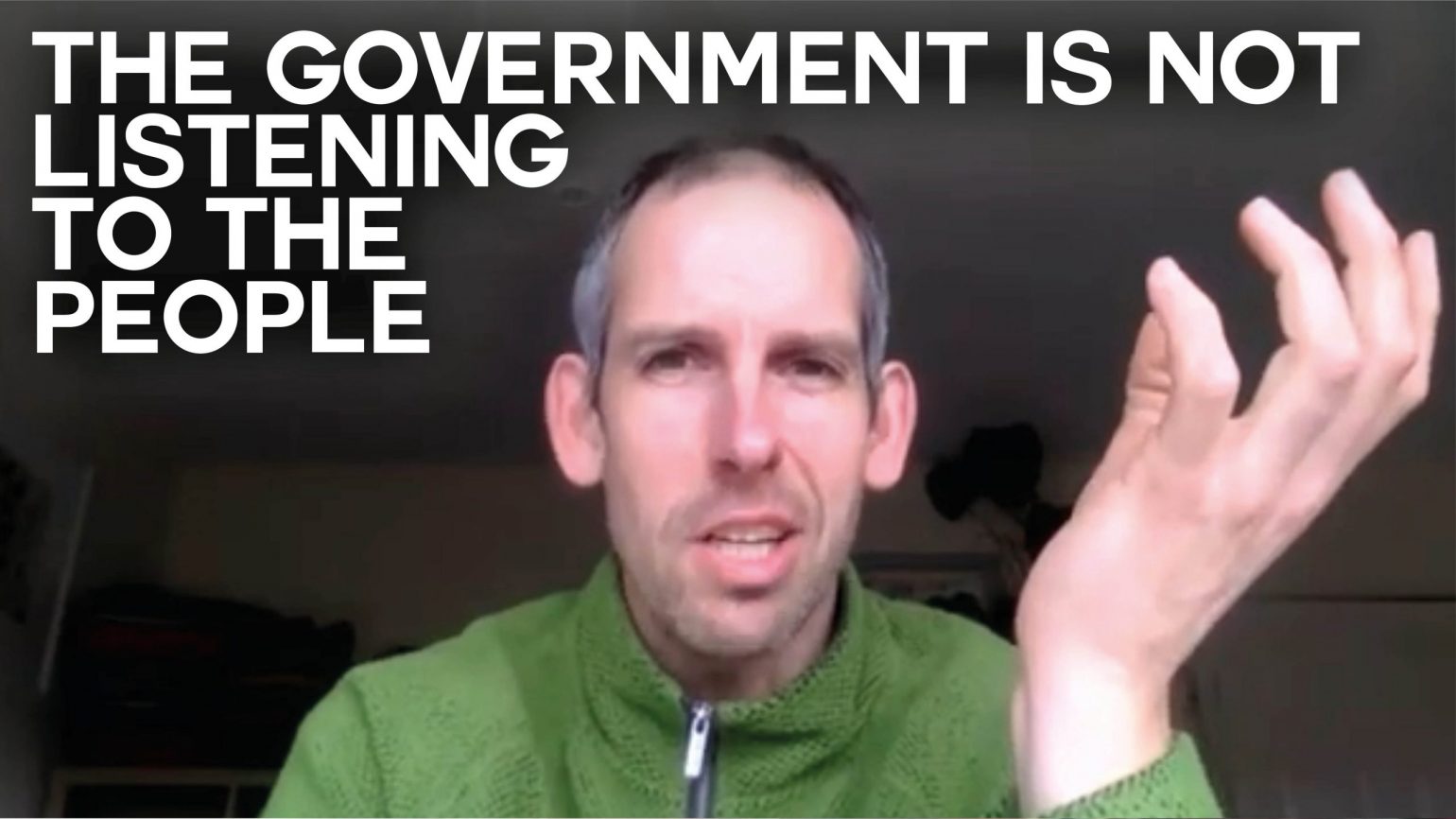 A still of an interview with Extinction Rebellion activist Etienne Stott with text overlaid reading "The government is not listening to the people"