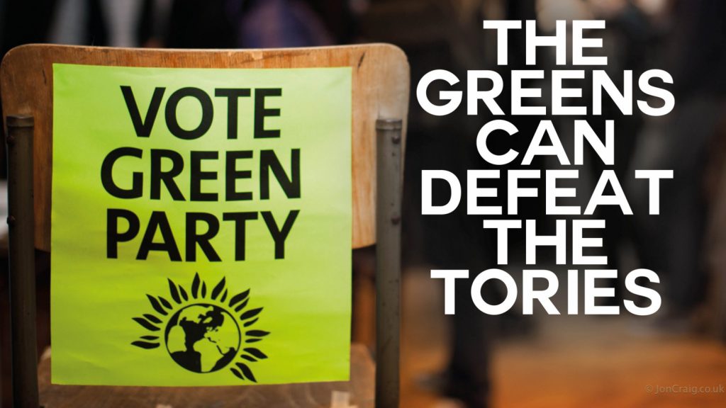 A photo of a chair with a "Vote Green Party" poster on it. To the right of it there is text reading "The Greens can defeat the Tories"