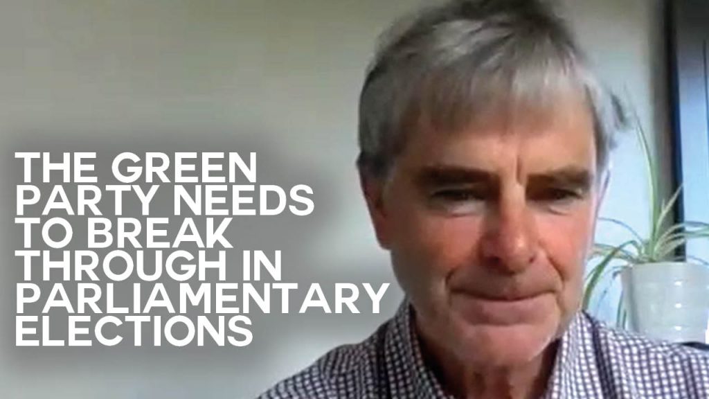 A still of an interview with Edward Milford with text overlaid reading: "The Green Party Needs to break through in parliamentary elections"