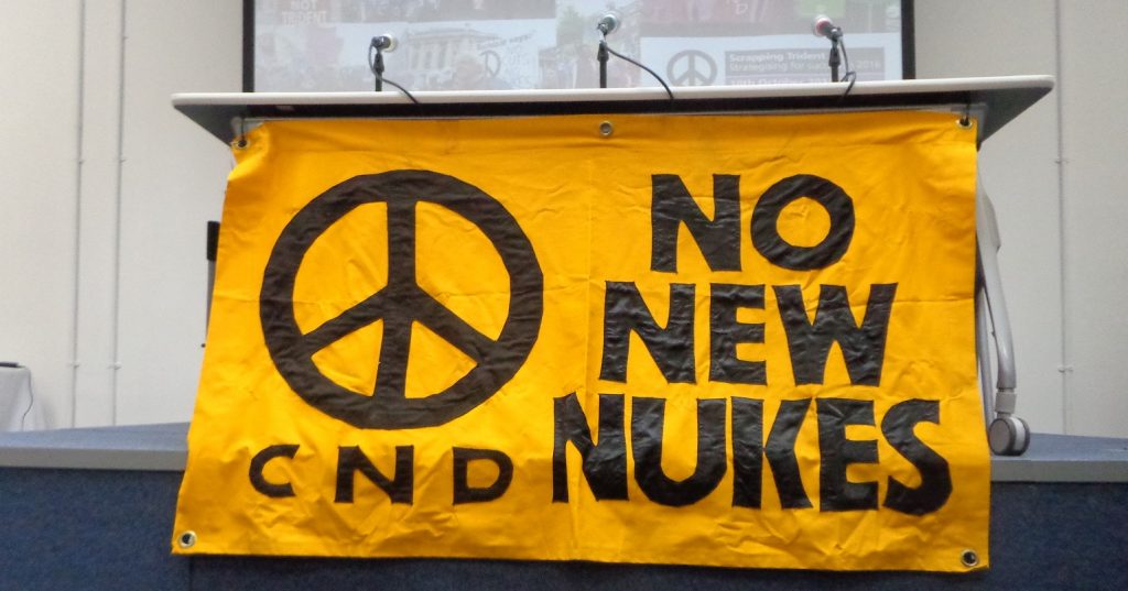 A CND banner reading "no new nukes"