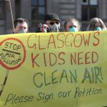 Anti air-pollution protesters holding a banner reading "Glasgow's kids need clean air"