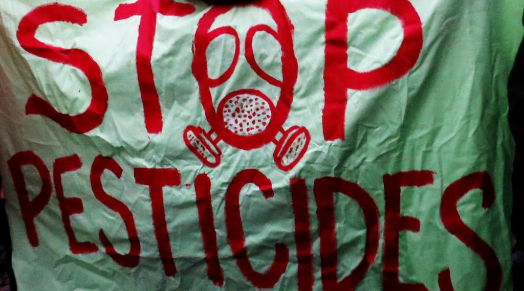 A banner reading "Stop pesticides"