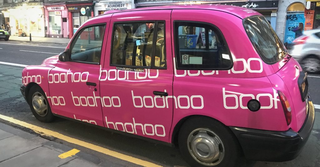 A taxi with Boohoo advertising